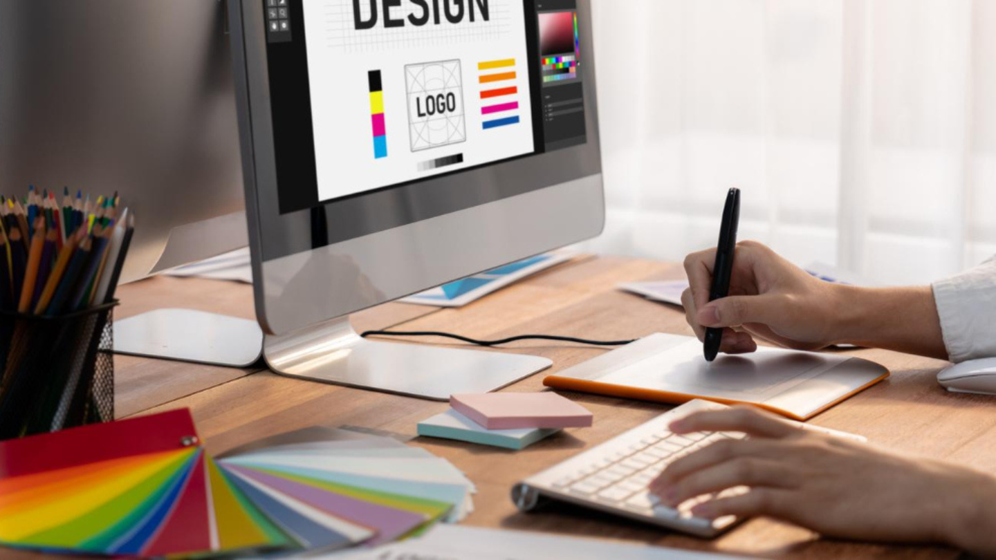 Graphic designer works on computer laptop with digital pen