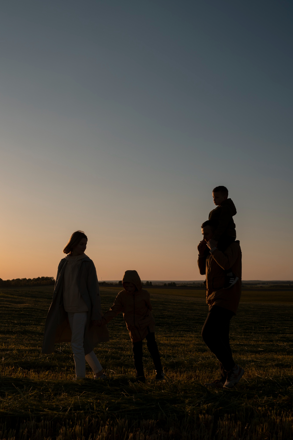family silhouette having fun at sunset